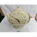An unusual retro clock in the shape of a teapot.