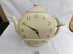 An unusual retro clock in the shape of a teapot.