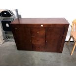 A dark wood 2 door, 3 drawer sideboard.