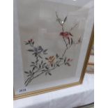 A framed and glazed silk embroidery of birds and flowers.