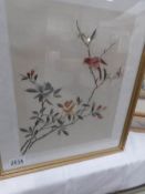 A framed and glazed silk embroidery of birds and flowers.