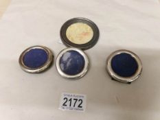 3 small circular silver photo frames and an unmarked photo frame.