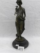 A bronze figure of a lady.