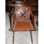 An oak ecclesiastical chair.