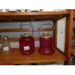 2 cranberry glass biscuit barrels with plated fittings.