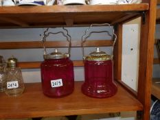 2 cranberry glass biscuit barrels with plated fittings.