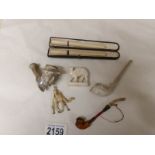 A cheroot holder in the shape of a pipe, 2 other cheroot holders,