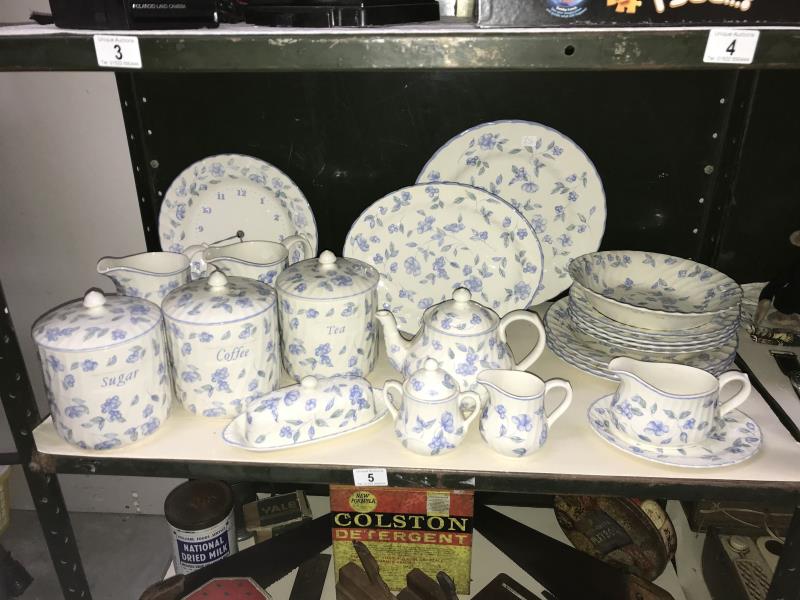 A blue and white dinner set, including storage jars and clock etc.
