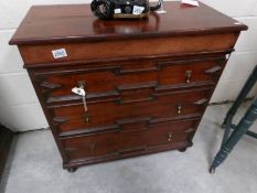 A mahogany chest of drawers.