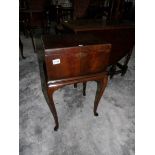 A mahogany sewing box on stand.