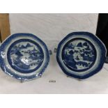 A pair of 19th century blue and white willow pattern food warming plates.