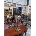 A brass oil lamp with glass font and complete with chimney.