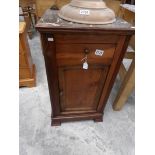 A marble topped pot cupboard.