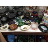 A large collection of pot and glass pub ashtrays.