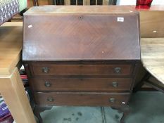 A 1930's mahogany bureau with string inlay on Queen Anne legs