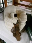 A bag containing £5 in old half pennies.