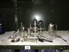 A collection of silver plate items including coffee pot, tongs etc.