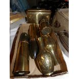 A collection of brass trench art items.