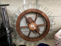 A spice rack in the shape of a ships wheel.