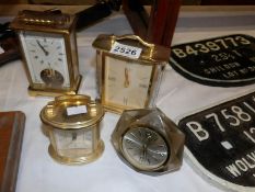 A brass carriage clock and 3 other clocks.