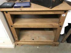 A dark stained pine bookcase
