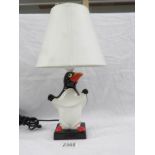 An original Carlton ware penguin table lamp with shade.