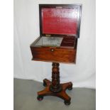 A Victorian rosewood tea table / teapoy on stand with 2 tea caddies.