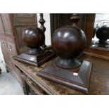 A pair of globe shaped wood staircase finials.