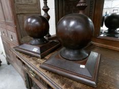 A pair of globe shaped wood staircase finials.