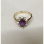 A 9ct gold ring set diamonds and central pear shaped amethyst, size O half, gross weight 3 grams.