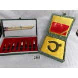 A jade 'The Dragon Jade' amulet and a Chinese calligraphy set.