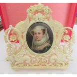 An early Victorian hand painted miniature portrait in a carved ivory frame.