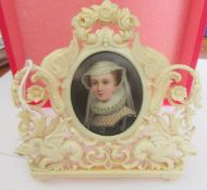 An early Victorian hand painted miniature portrait in a carved ivory frame.