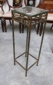 A metal plant stand with glass top.