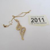 An 18ct gold pendant on an 18ct gold chain.