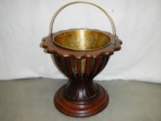 A circular Victorian mahogany planter with scalloped edge complete with brass liner.