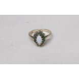 A 9ct gold ring set opal and emeralds, size M. Gross weight 2 grams.
