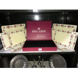 A 14 piece boxed Royal Albert plate/coaster mats