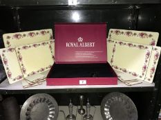 A 14 piece boxed Royal Albert plate/coaster mats