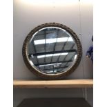 A round gilt framed mirror