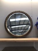 A round gilt framed mirror