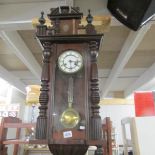 A mahogany wall clock.