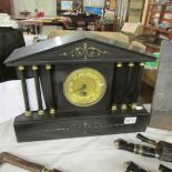 A heavy slate Palladian style clock with key.