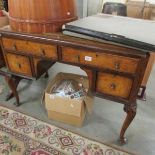 A walnut writing desk with leather top.