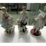 A pair of continental porcelain figures of shepherd and shepherdess together with one other figure.