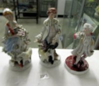 A pair of continental porcelain figures of shepherd and shepherdess together with one other figure.