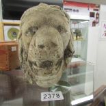A stone head of a lion.