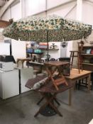 A garden table with 2 parasols and small table