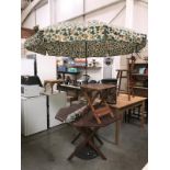 A garden table with 2 parasols and small table