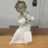 A Lladro cherub with flute figure.